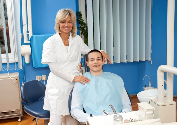 Žena zubař s mužský pacient — Stock fotografie