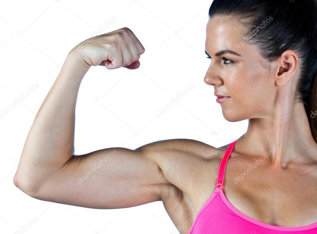 Strong woman shows her arm muscles with power Stock Photo - Alamy