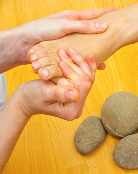 Female foot on massage spa treatment — Stock Photo, Image
