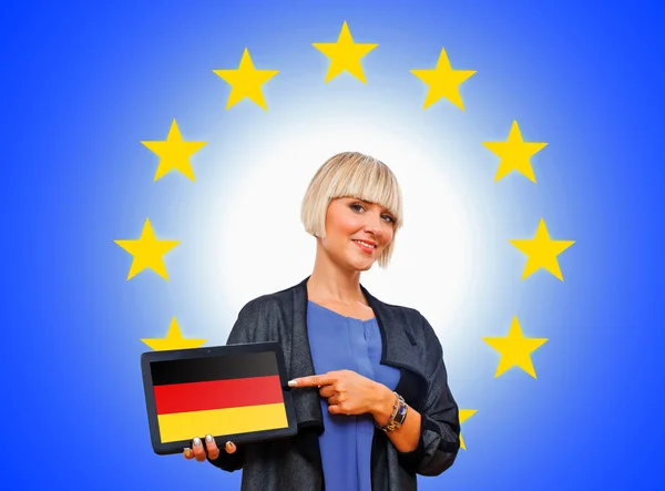 Woman holding tablet with united german on european union backg — Stock Photo, Image