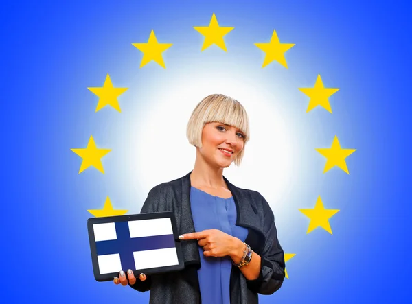 Woman holding tablet with finland flag on european union backgr Stock Picture