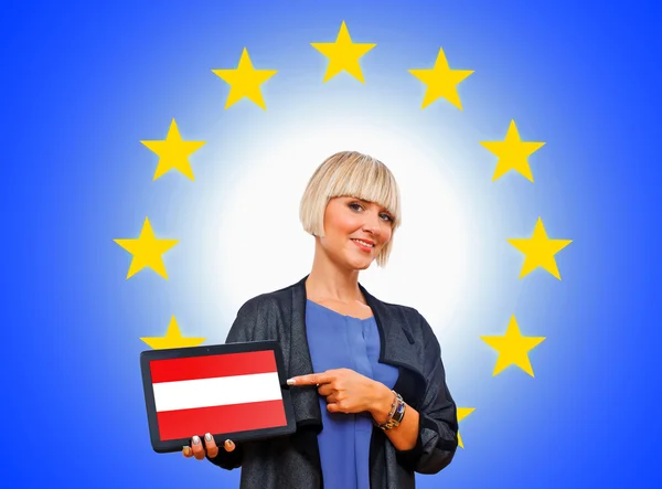 Woman holding tablet with austrian flag on european union backg — Stock Photo, Image