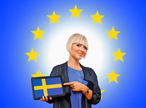 Woman holding tablet with sweden flag on european union backgro Stock Picture