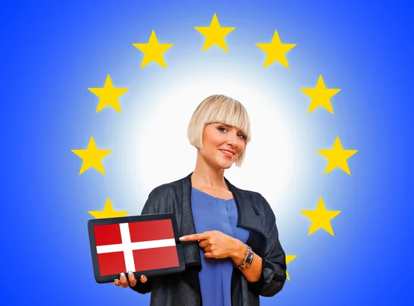 Woman holding tablet with denmark on european union background Stock Picture