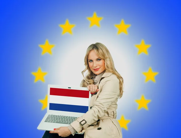 Woman holding laptop with netherlands flag — Stock Photo, Image