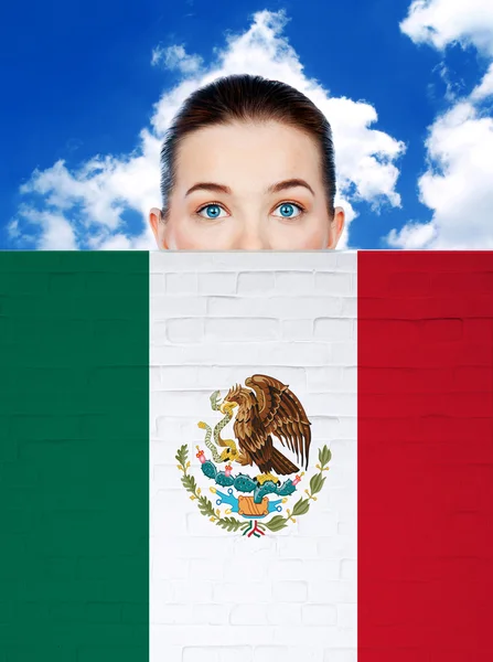 Womanl face behind wall with mexican flag — Stock Photo, Image