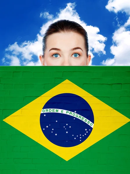 Woman face behind wall with brazil flag — Stock Photo, Image