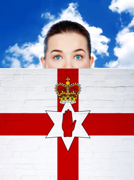 Woman face behind wall with northern ireland flag — Stock Photo, Image