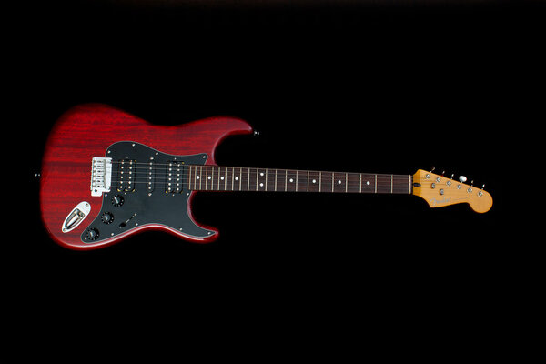 ZAGREB , CROATIA - JANUARY 14 ,2014 : fender stratocaster red electric guitar on black background , product shot