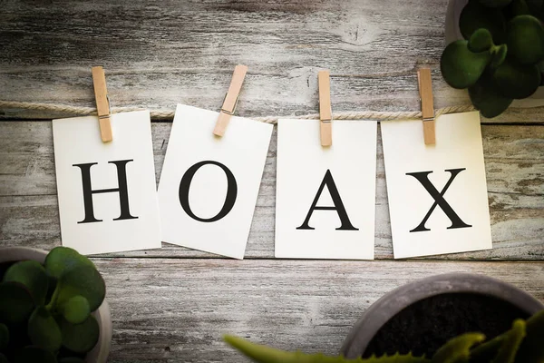Set Printed Cards Spelling Word Hoax Aged Wooden Background — Stock Photo, Image