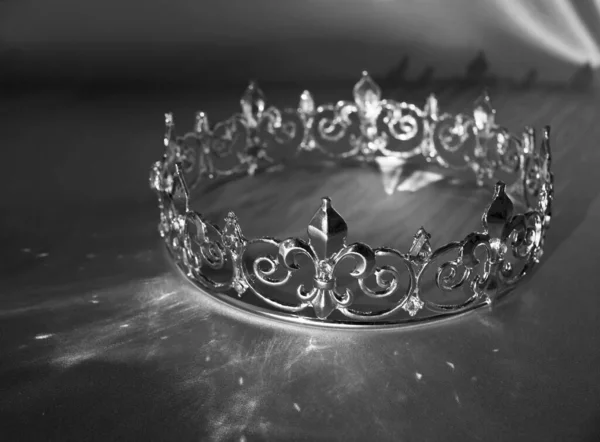 Vintage royal round king crown. Symbol of power and wealth. Black and white photo, monochrome.