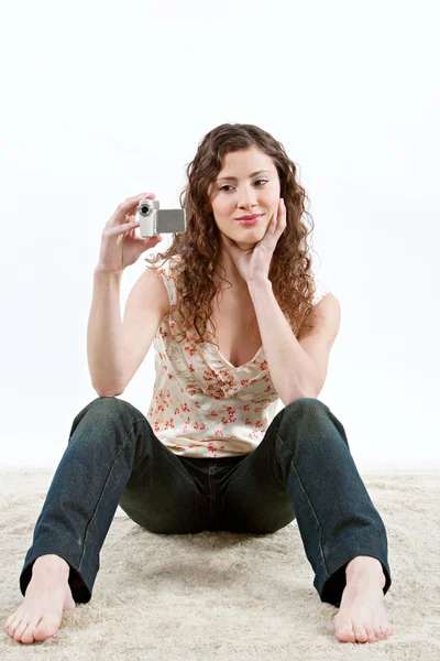 Teenage girl using a small video camera to film — Stock Photo, Image