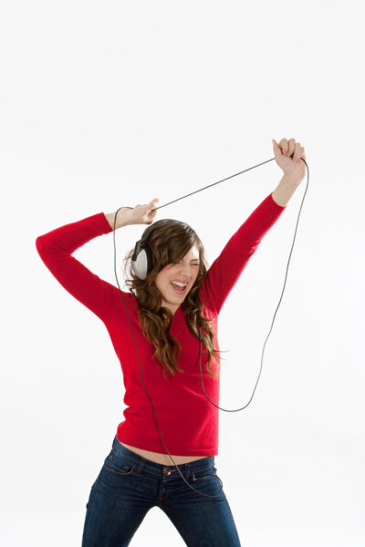 young woman singing and dancing while listening to music