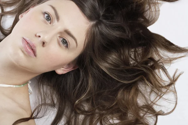 Over head portrait of a young woman laying down — Stock Photo, Image