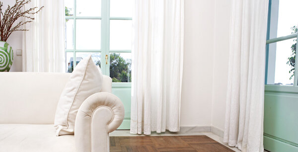 Stylish home living room with white sofa and glass doors.