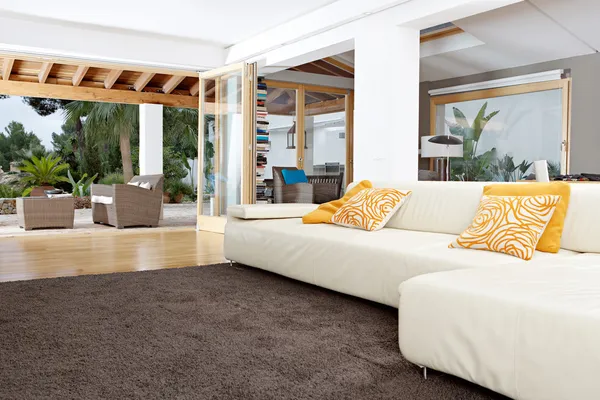 Interior of a well designed home's living room with garden views. — Stock Image Interior of a well designed home's living room with garden views. Stock Picture