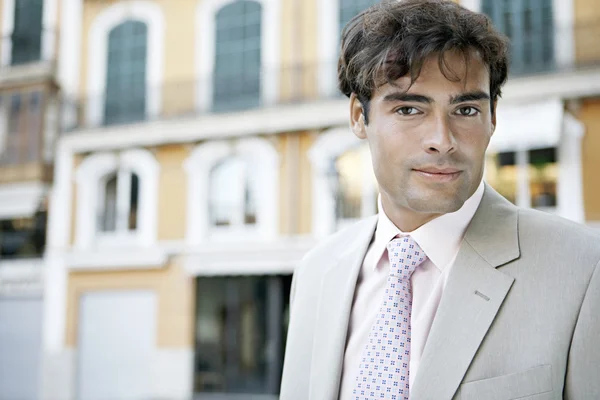 Portrait of a young businessman in a European city background. — Stock Photo, Image