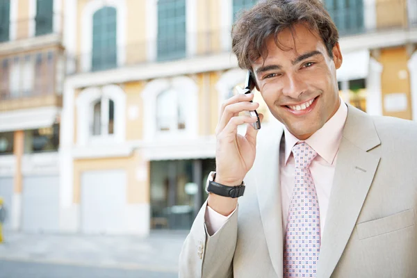 Attractive businessman in a European city with classic office buildings in the background — Stock Photo, Image