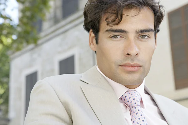 Close up portrait of an attractive young businessman in a classic setting outdoors. — Stock Photo, Image