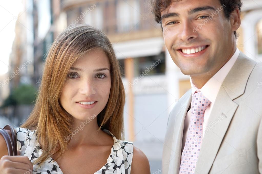 Portrait of a businessman and a businesswoman standing together in a classic office buildings street