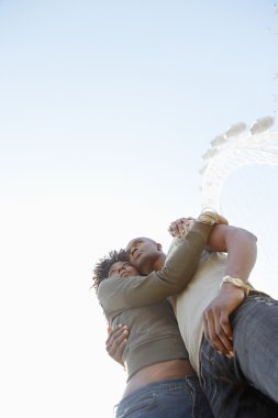 mavi bir gökyüzü karşı sarılma çekici siyah Çift