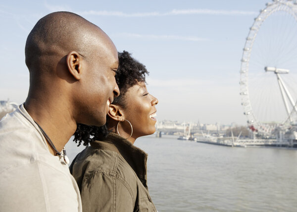 African american couple on Westminster Bridge looking at London's skyline