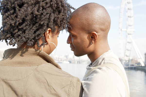 Attractive black couple standing by the river Thames