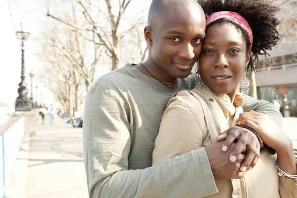 attractive african american couple visiting London and hugging