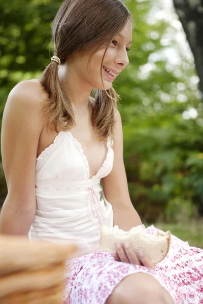 Close up of teenage girl having a picnic in the forest. — Stock Photo, Image