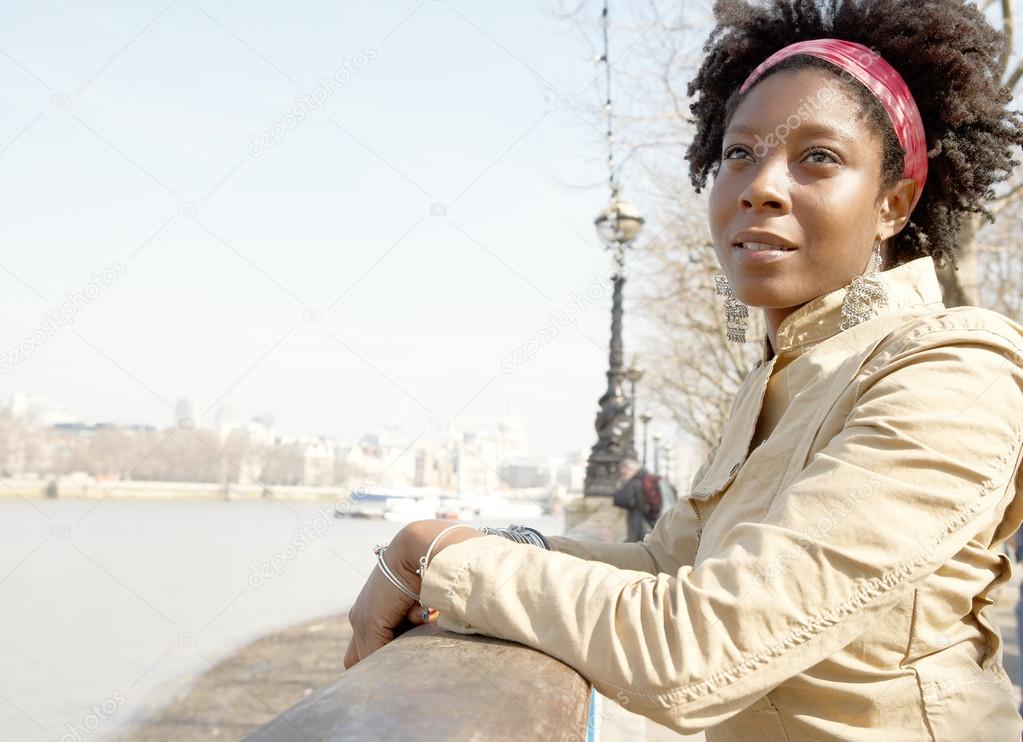 african american woman sightseeing in London's river Thames