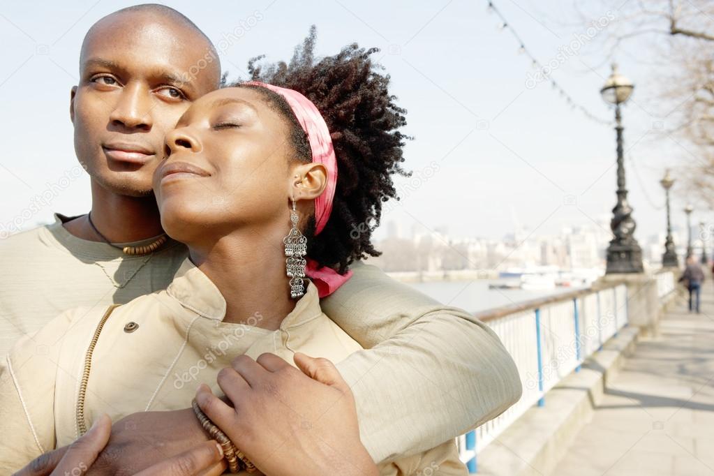 african american couple visiting London city and hugging