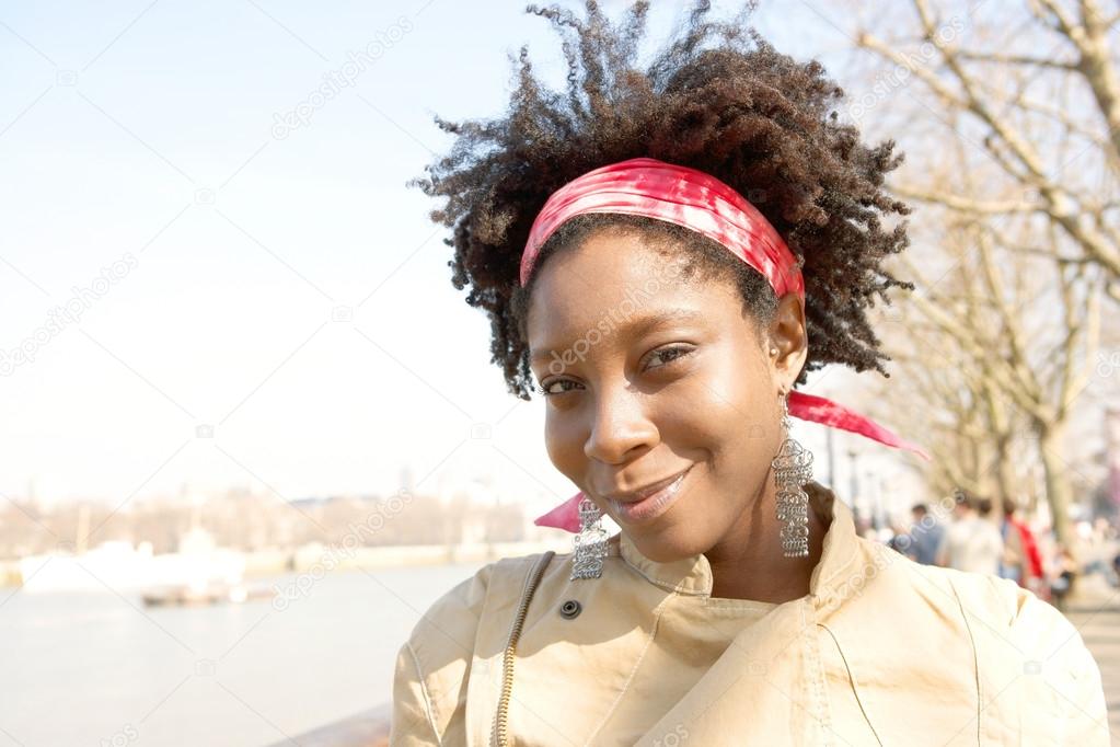 african american woman sightseeing in London's river Thames
