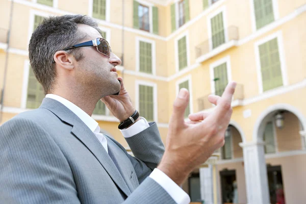 Businessman using a smart phone to have a conversation — Stock Photo, Image