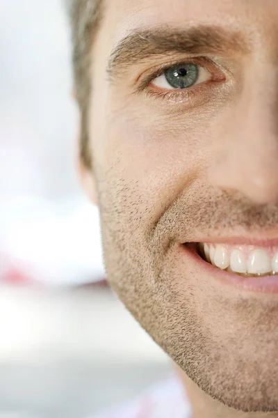 Close up view of half the face of a senior businessman smiling outdoors. — Stock Photo, Image