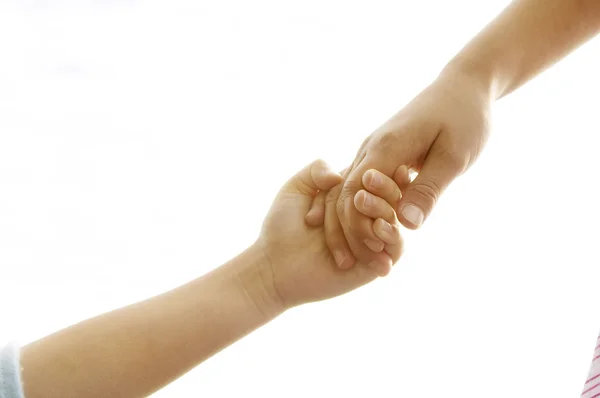 Hands being held together against the sky. Stock Photo