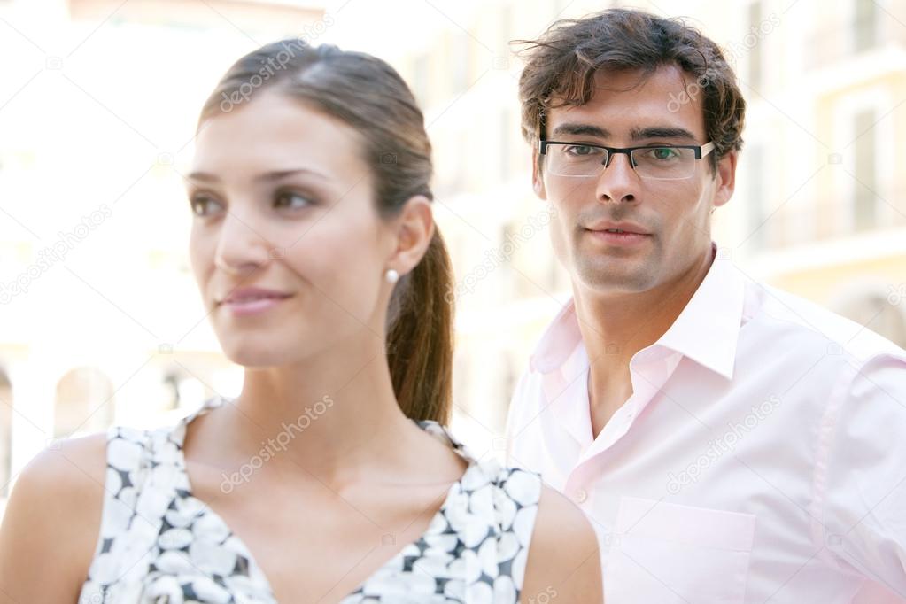 Attractive young businesswoman and businessman standing together