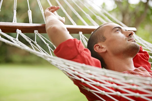 Young man laying down on a hammock — Stock Photo, Image