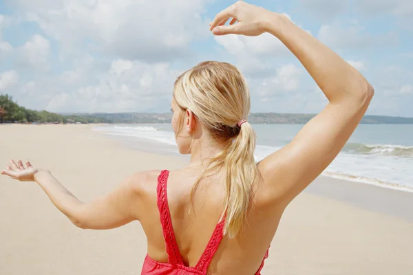 Young woman practicing martial arts while standing by the shore — Stock Photo, Image