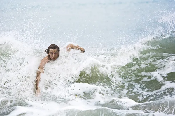 Young man swimming large ocean waves. — Stock Photo, Image