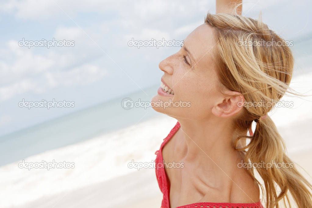 attractive woman dancing on a beach with the horizon and the sky