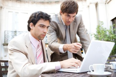 Two businessmen focused on having a meeting clipart