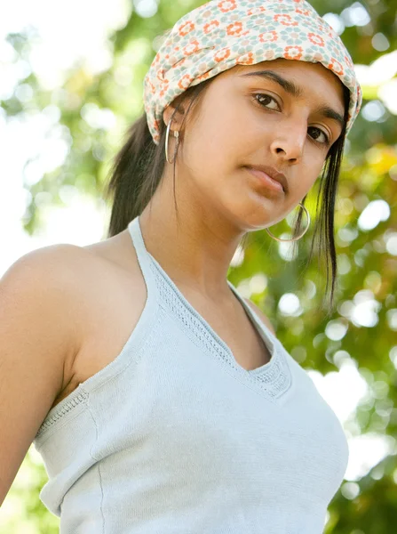 India adolescente mirando la cámara con árboles follaje en el fondo . —  Fotos de Stock