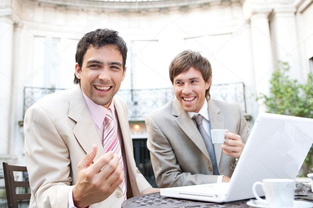 Two businessmen laughing while having a meeting