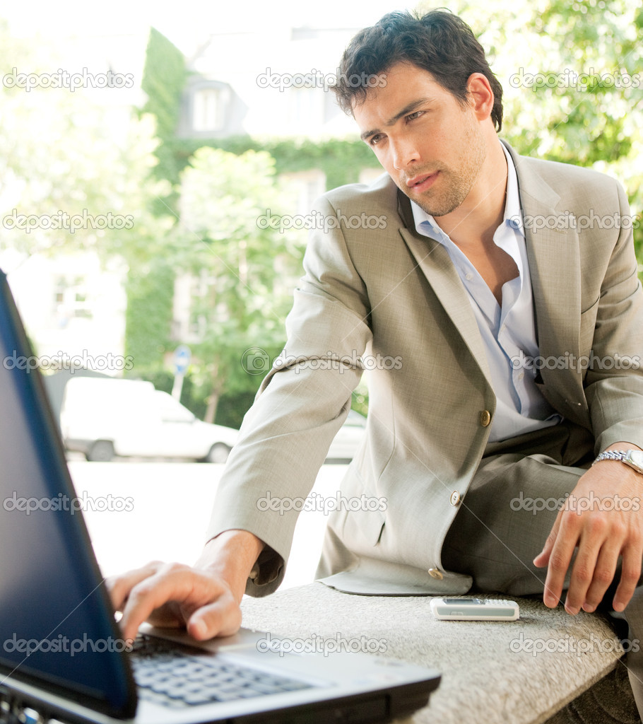 Attractive young businessman using a laptop computer