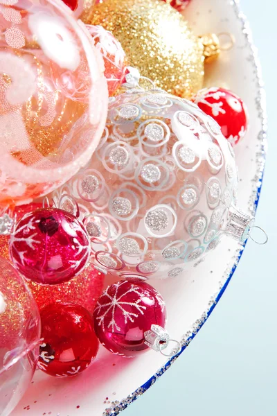 Bunch of different size and design christmas balls in a silvery dish — Stock Photo, Image