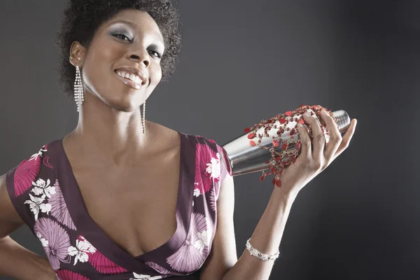 Attractive young woman using a cocktail shaker — Stock Photo, Image