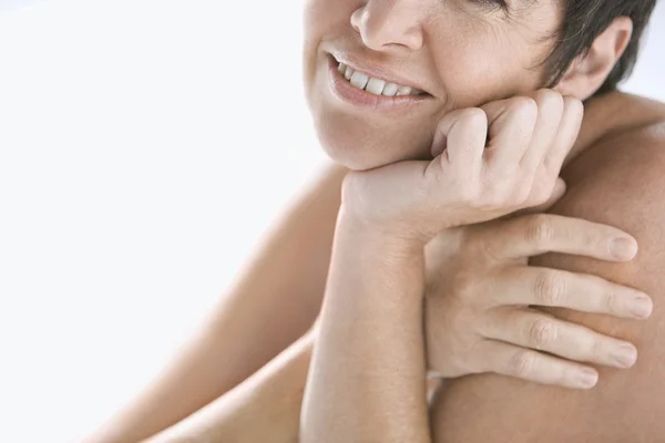 Mature nude woman against a white background — Stock Photo, Image