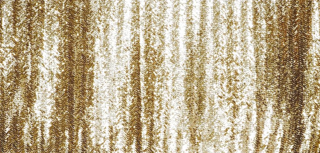 Full frame gold sequins curtain background texture.