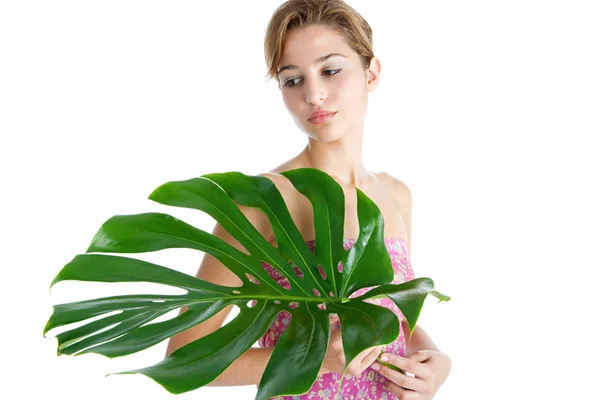 Beauty portrait of a young woman holding tropical green leaf — Stock Photo, Image