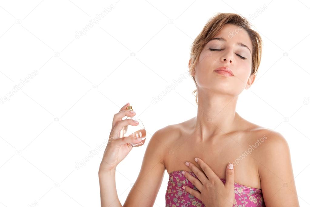 portrait of a young beautiful woman spraying perfume on herself